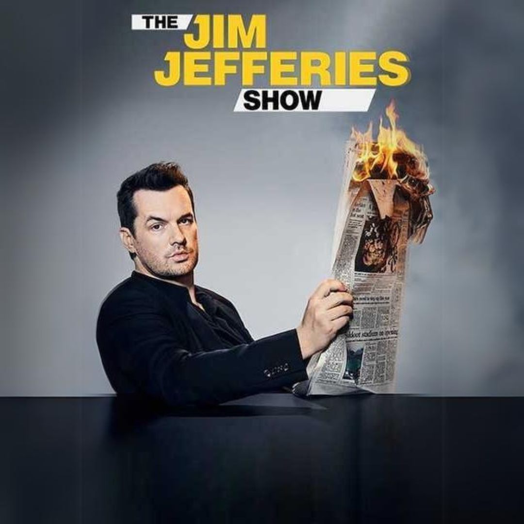 Portrait of Jim Jefferies posing with a burning newspaper at Royal on the Park Hotel