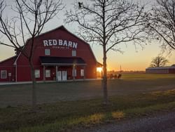 Exterior view of Red Barn Brewing during sunset near Retro Suites Hotel