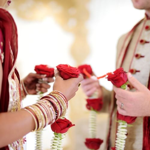 Close-up of couple holding roses at an indian wedding at One World Hotel in Petaling Jaya