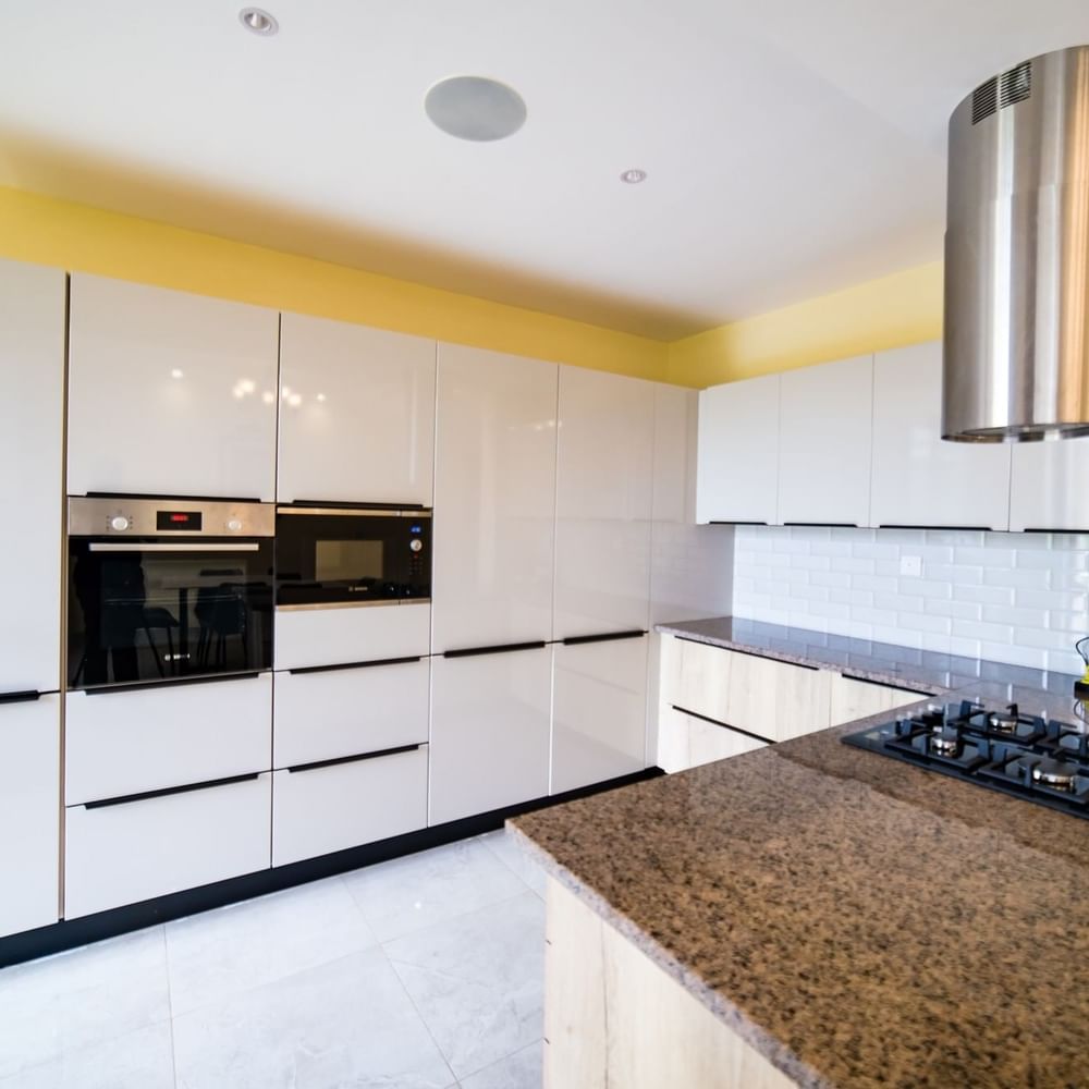 Modern kitchen with granite countertops and white cabinets at Lake Victoria Serena Golf Resort & Spa in Kampala.