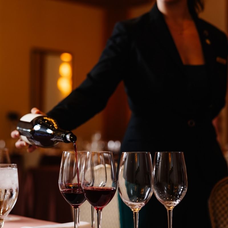Hannah S pouring wine for a wine masterclass
