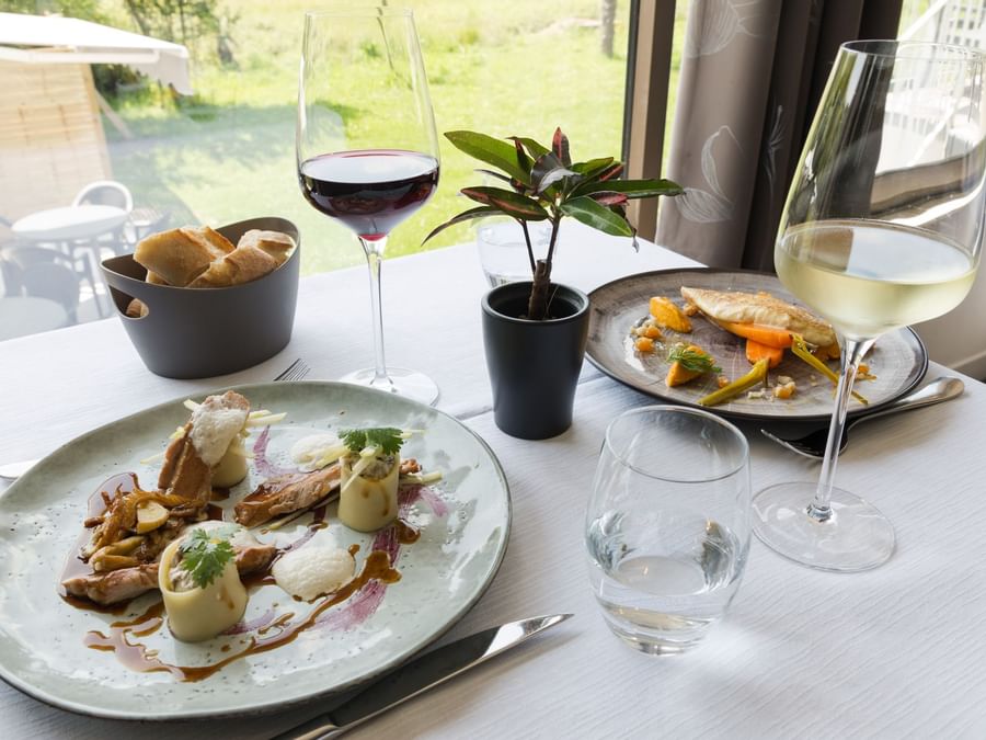 Closeup of Meals served with wine at Hotel Les Quatre Salines
