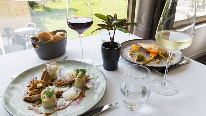 Closeup of Meals served with wine at Hotel Les Quatre Salines