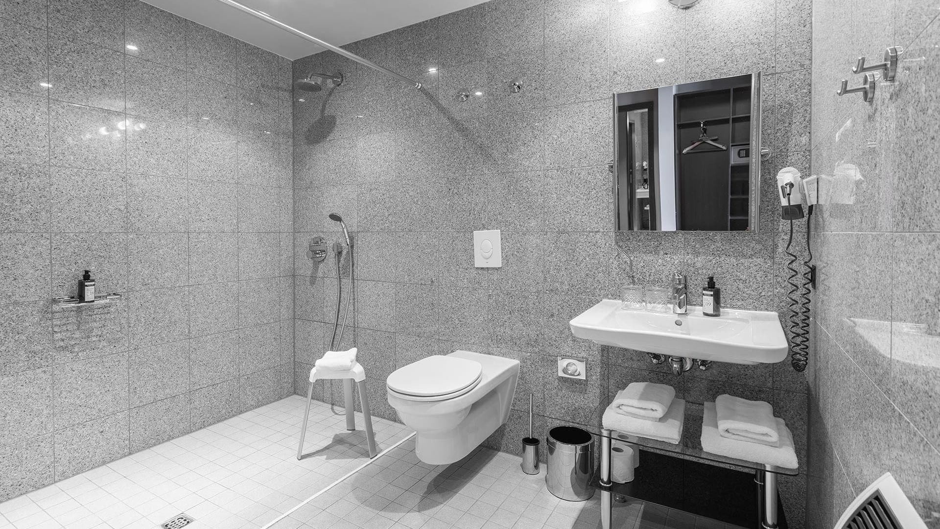 Grayscale photo of a bathroom in Superior Room at Titanic Comfort Kurfürstendamm