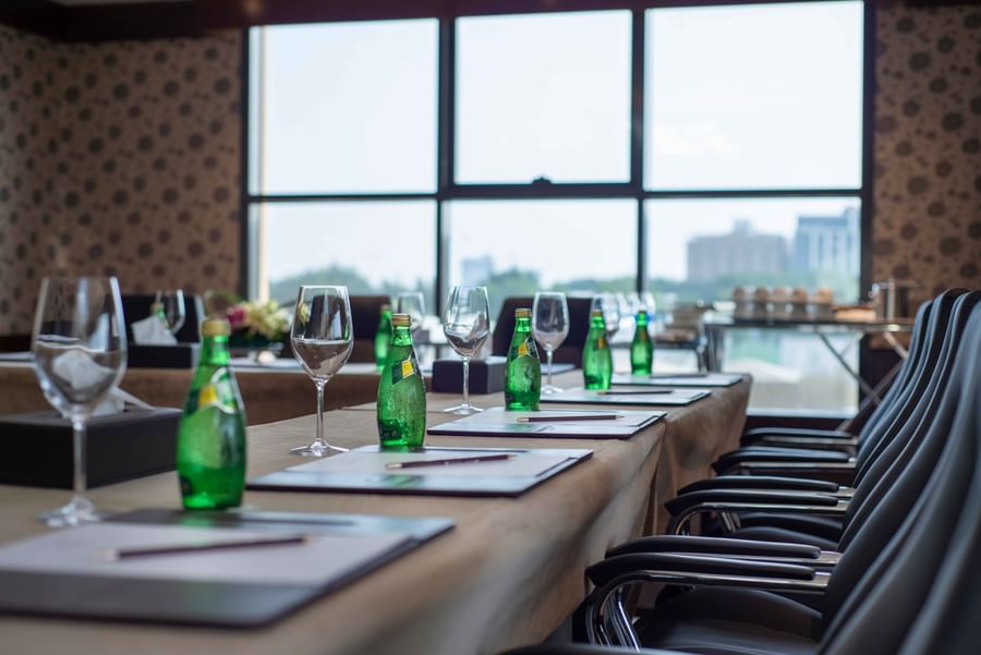 Meeting room features Glass water bottles and crystal stemware at Warwick Al Khobar