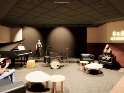 People enjoying music in a cozy lounge area with instruments and a grand piano.
