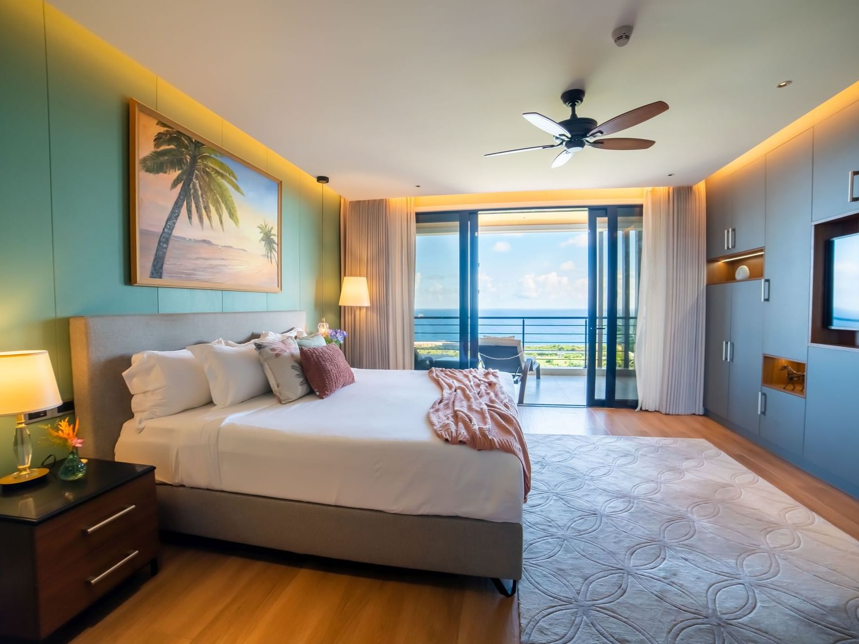 Golden Rock Suite with a king bed, ocean views, tropical decor, and a balcony at Golden Rock Resort