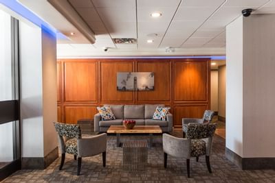Lobby with sofa & accent chairs at Embassy Hotel & Suites