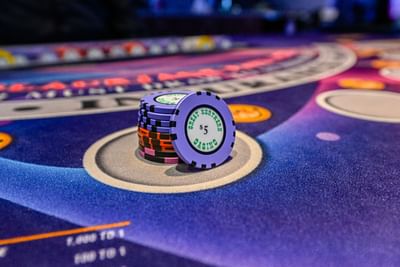 Close-up of a poker chip on a casino table at Encore Suites Grande Prairie