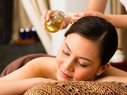 lady relaxing during massage at Amora Hotel