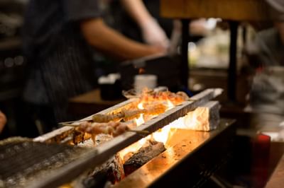 A chef grilling seafood on a barbecue at The Verb Hotel