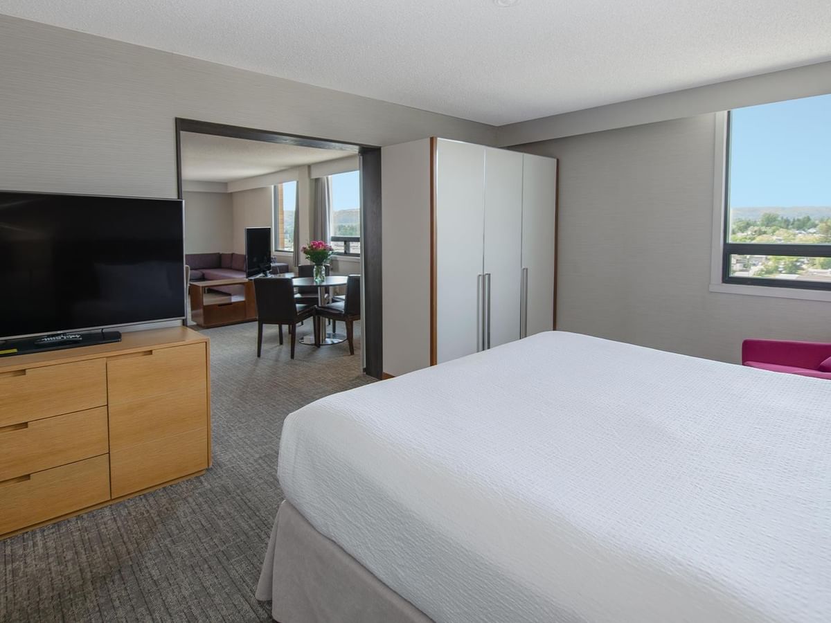 Coast Presidential King Suite with king bed, TV, wardrobe, and city views at Coast Prince George Hotel.