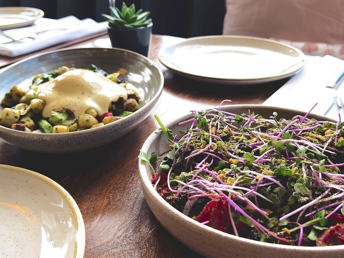 Two beautiful plates of food on a neatly set table
