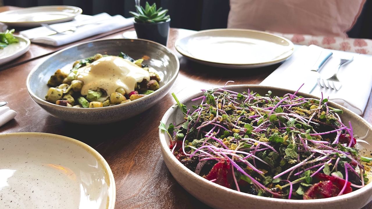 Two beautiful plates of food on a neatly set table