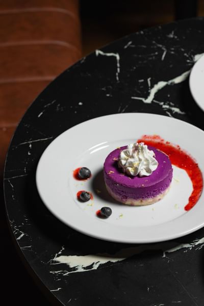 Purple mousse dessert with whipped cream served at Cypress & Oak, one of the best restaurants in Frankfort, KY