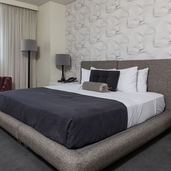 Large comfy bed in the Superior Room at Gamma Hotels