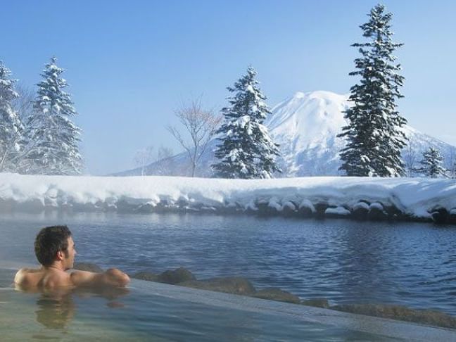 Man enjoying the Hotspring in Onsen near Chatrium Nisekoo Japan