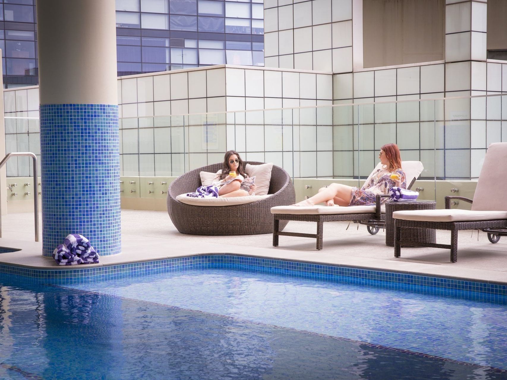 Ladies sitting near the pool at the Sebel Residence Chatswood
