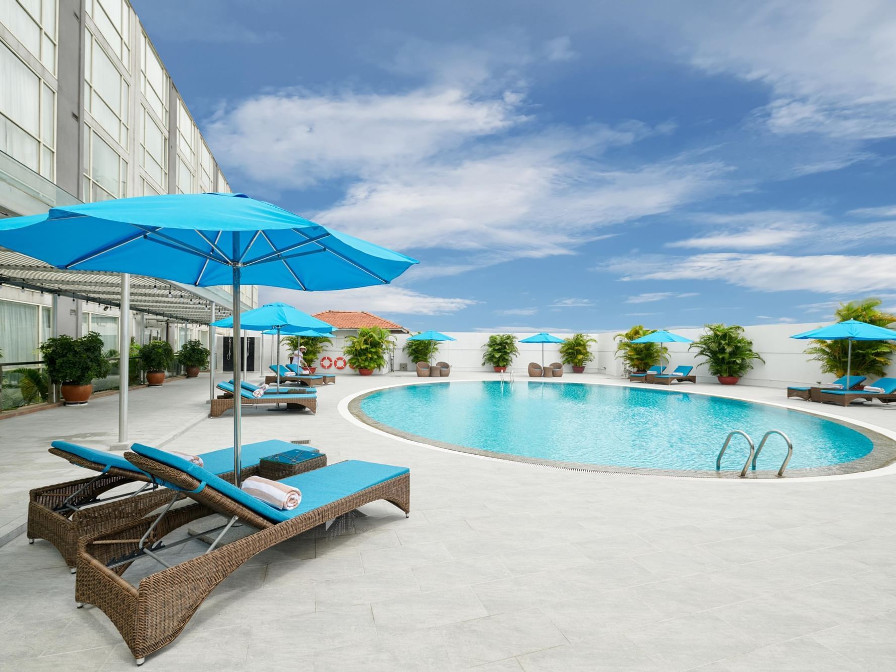 Outdoor swimming pool with pool beds at Eastin Grand Hotel Saigon