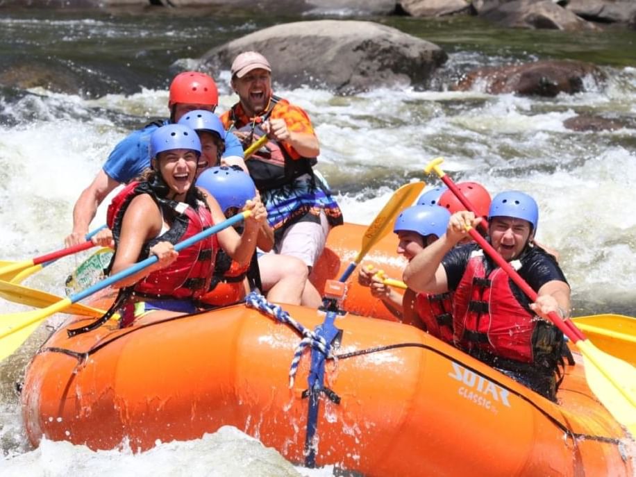 Male and female rafters on white water.