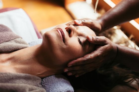 Close-up of a lady receiving a head massage at Liebes Rot Flueh