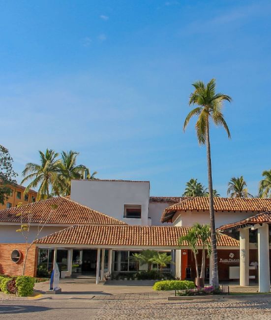 Hotel surrounded by palm trees, driveway & front entrance at Plaza Pelicanos Club Beach Resort 