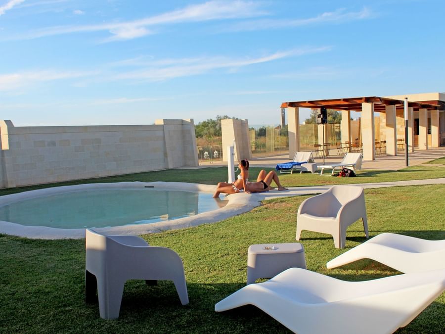 Outdoor pool area with pool beds at Masseria stali