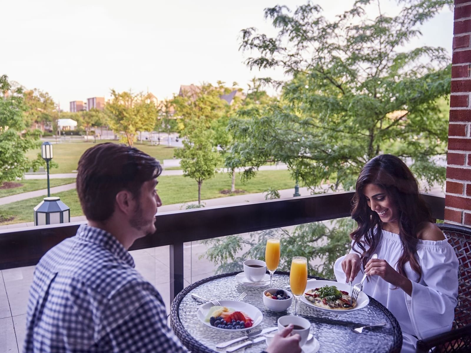 A couple enjoying a meal on a balcony at The Townsend Hotel