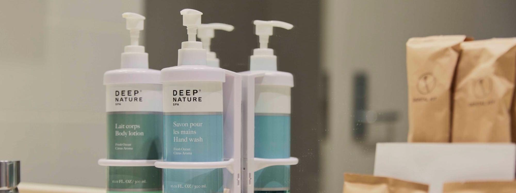 Reusable bathroom amenities displayed on a vanity mirror at Novotel Sydney on Darling Harbour