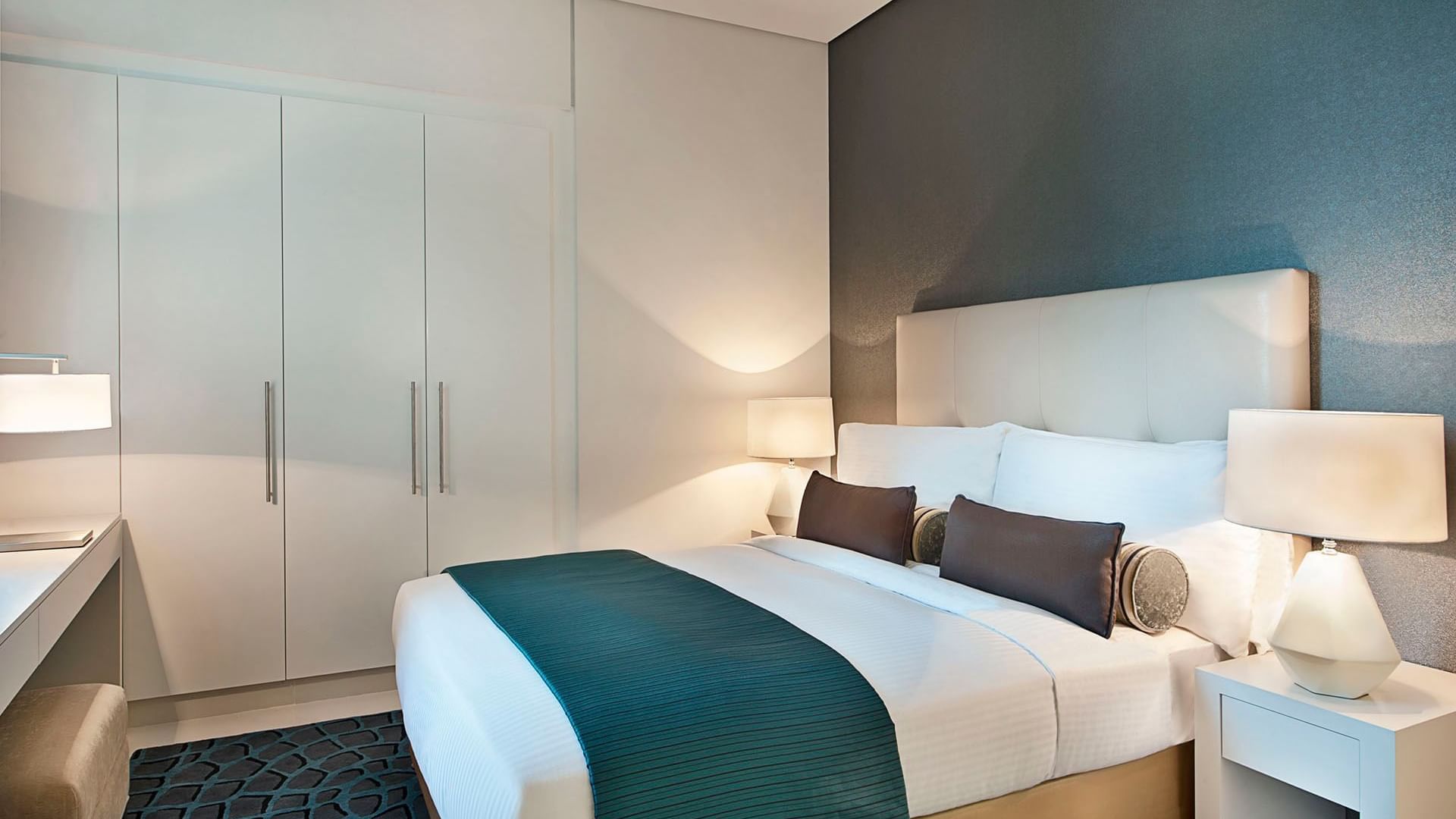 Modern furniture featuring a king bed & decor in One Bedroom Suite at DAMAC Maison Cour Jardin