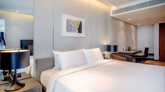 King bed with white bedding in Club Room at Amara Hotel BKK