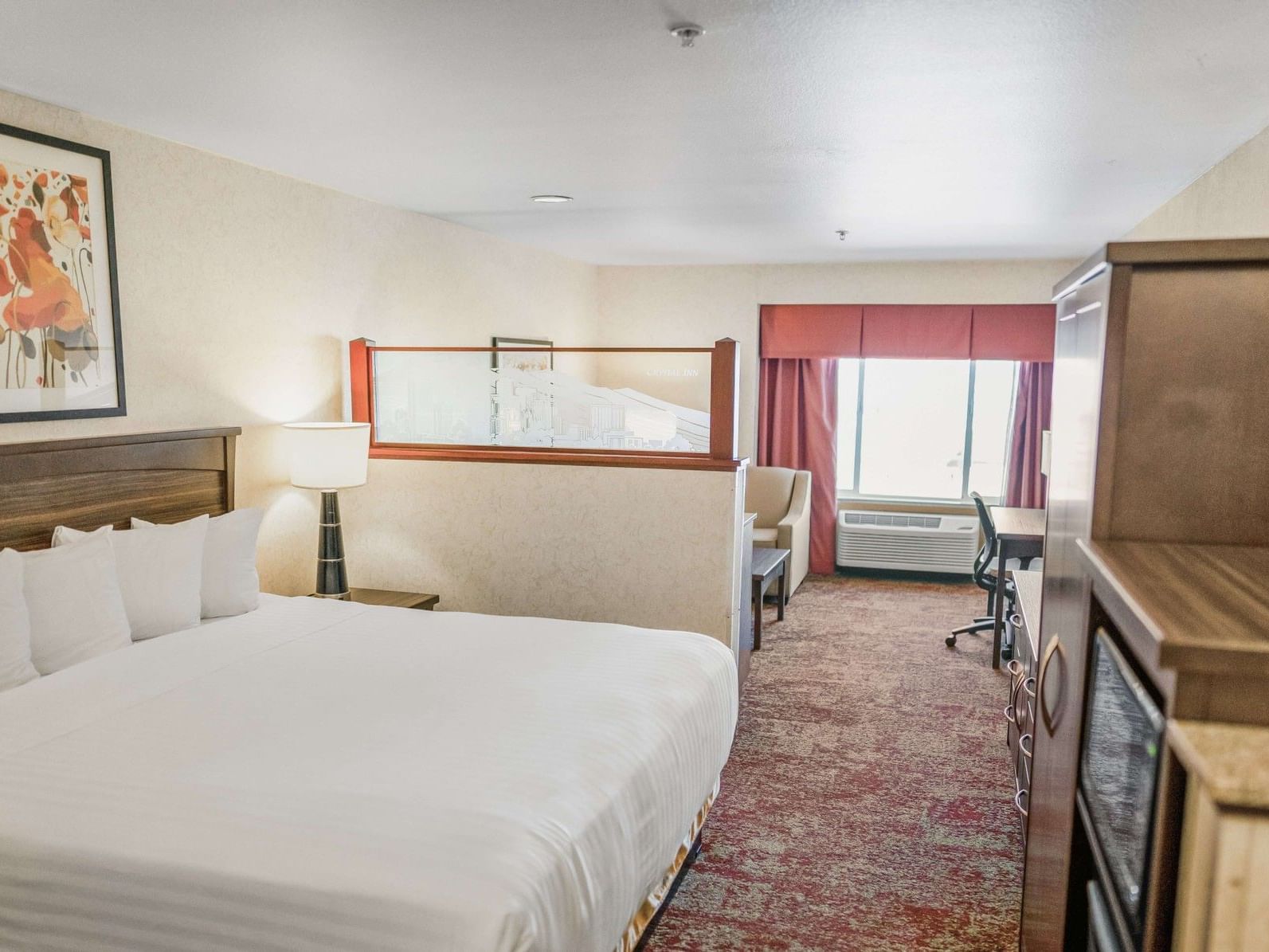 Standard King Bed Wall Non Smoking room with white bedding, floral artwork, and work desk at Crystal Inn Salt Lake City