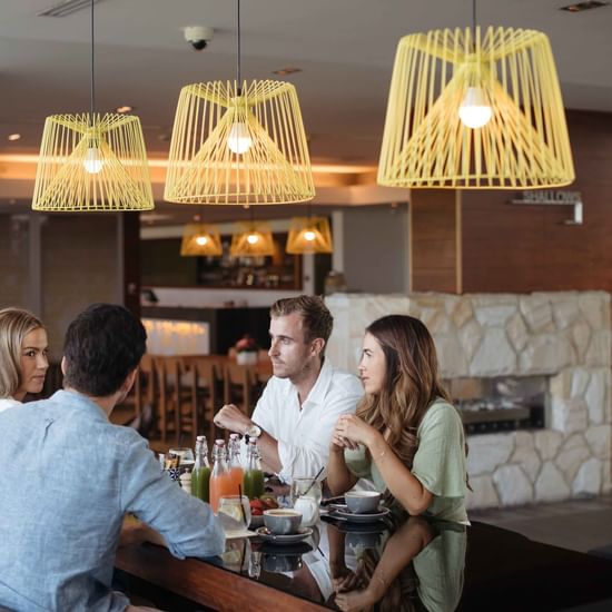 People enjoying meal in Shallows Bar at Pullman Magenta Shores