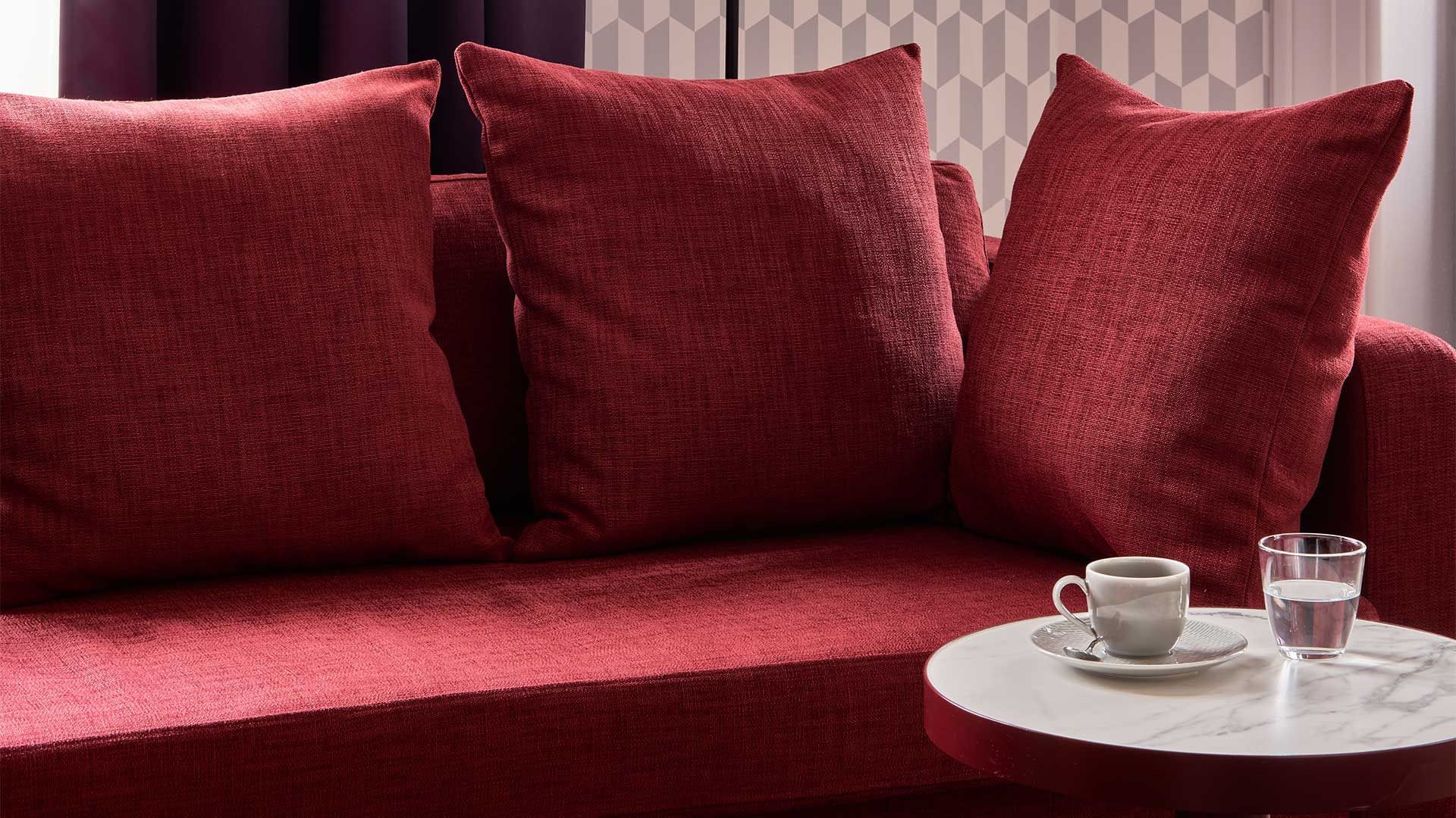 Red Lounge chair in Deluxe Room at Falkensteiner Hotels