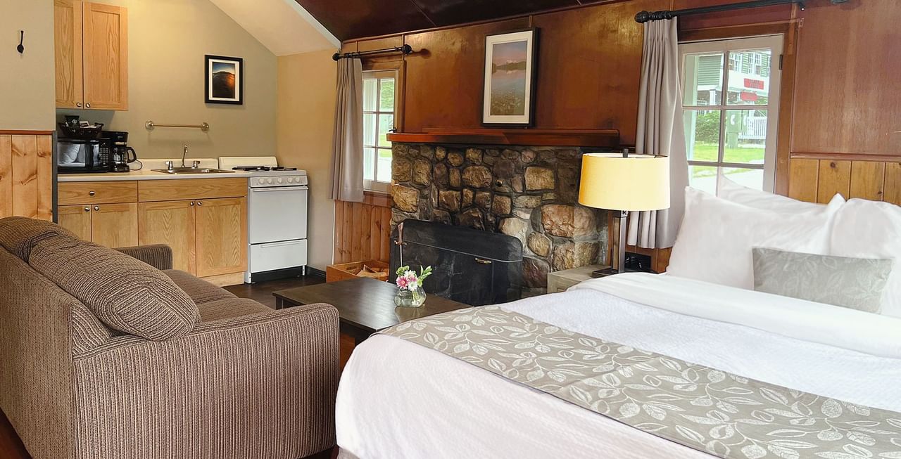 Interior of cabin with bed, sitting area, and kitchen