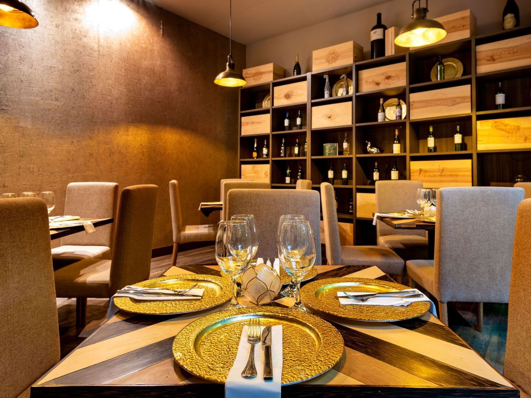 Dining area by a wine shelf in Cellar at Hotel Factory Green