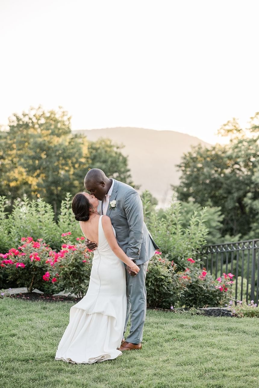 Wedding couple kissing in the garden at The Abbey Inn