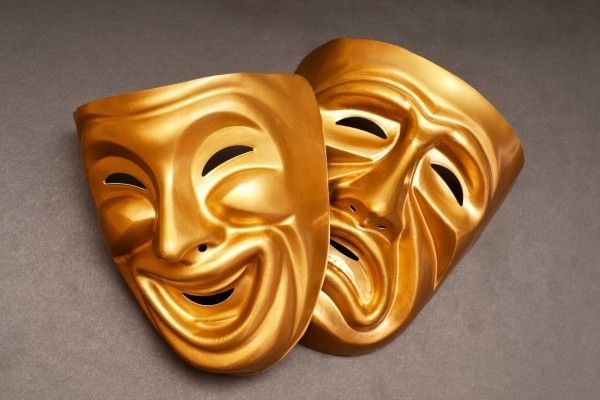 Traditional theatre masks representing comedy and tragedy.