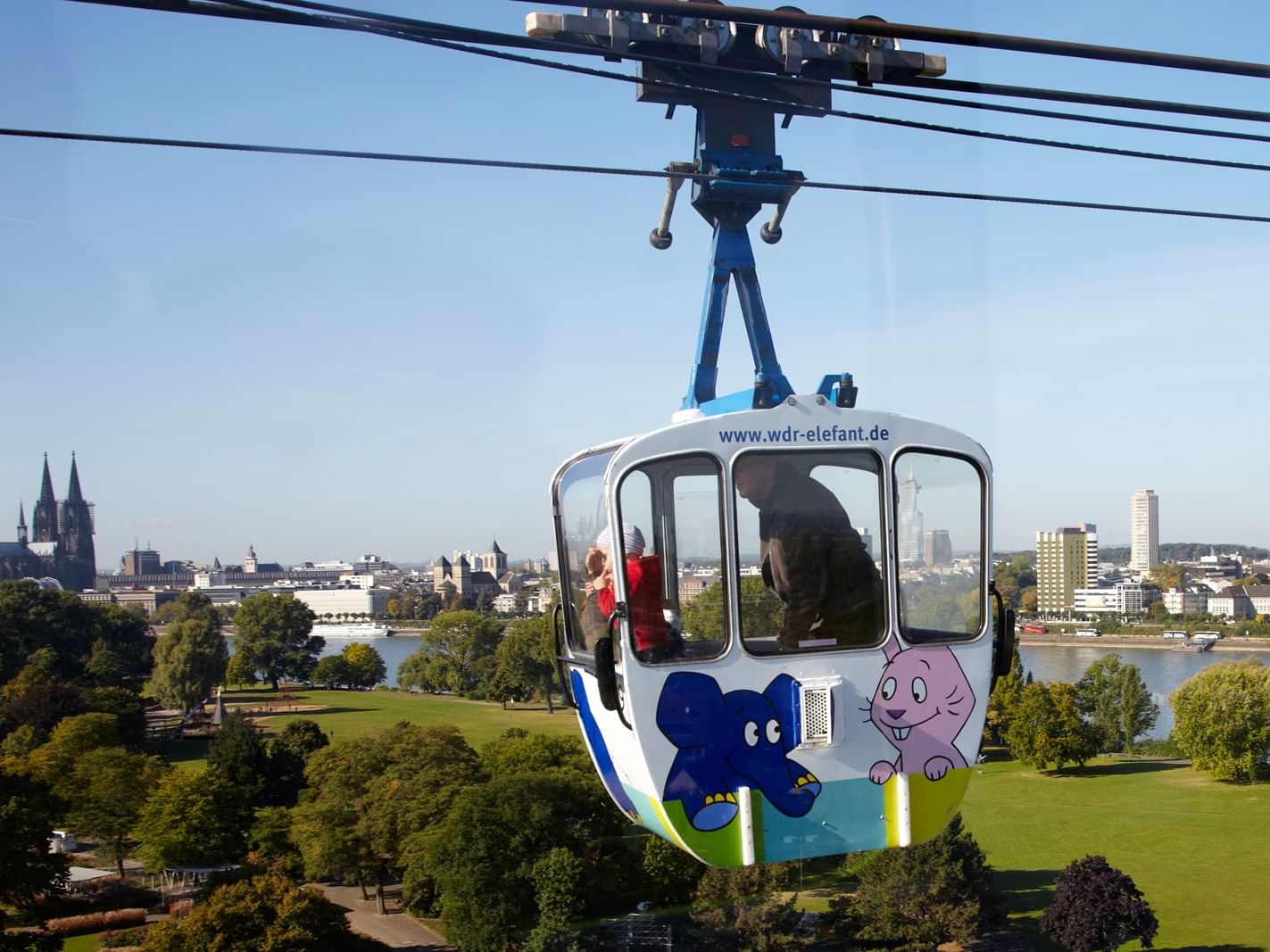Man & a kid in a Cable Car at Rhein-Seilbahn, Classic Harmonie