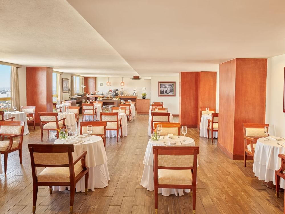 Dining area with wooden floors and buffet spread at Fiesta Americana