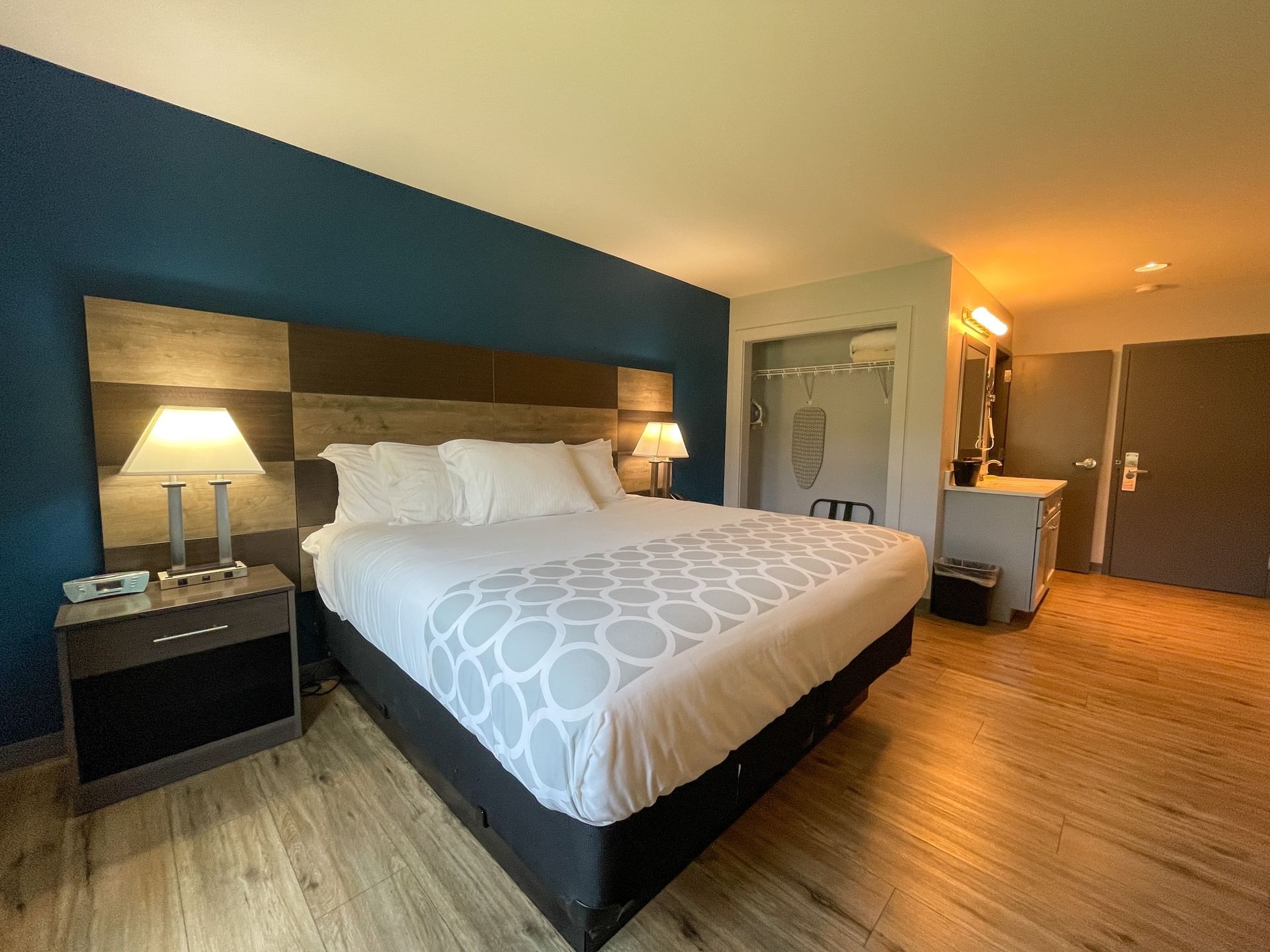 Comfy bed with pillows & lamps in King Room at The Inn at Canaan