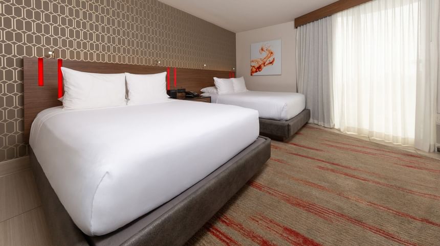 West Coast Double Room, with two queen beds, a geometric headboard, and red-patterned carpet at Hotel Angeleno