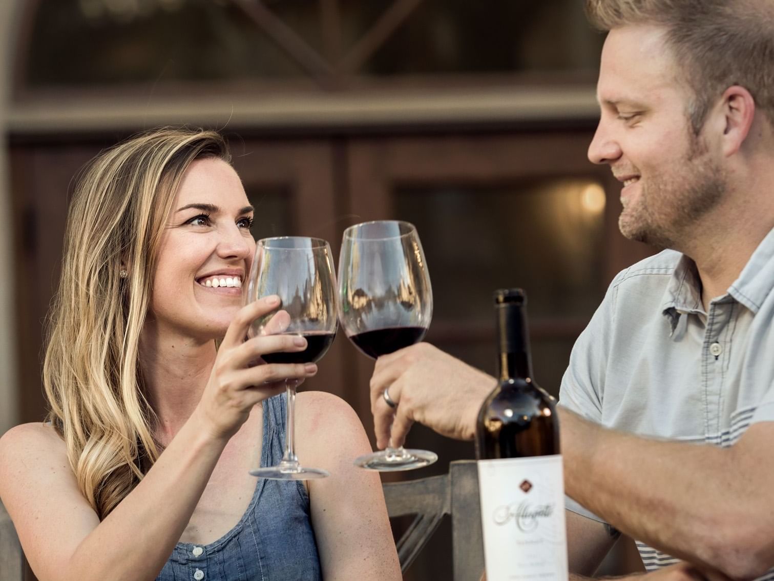 Woman and man toasting with wine glasses