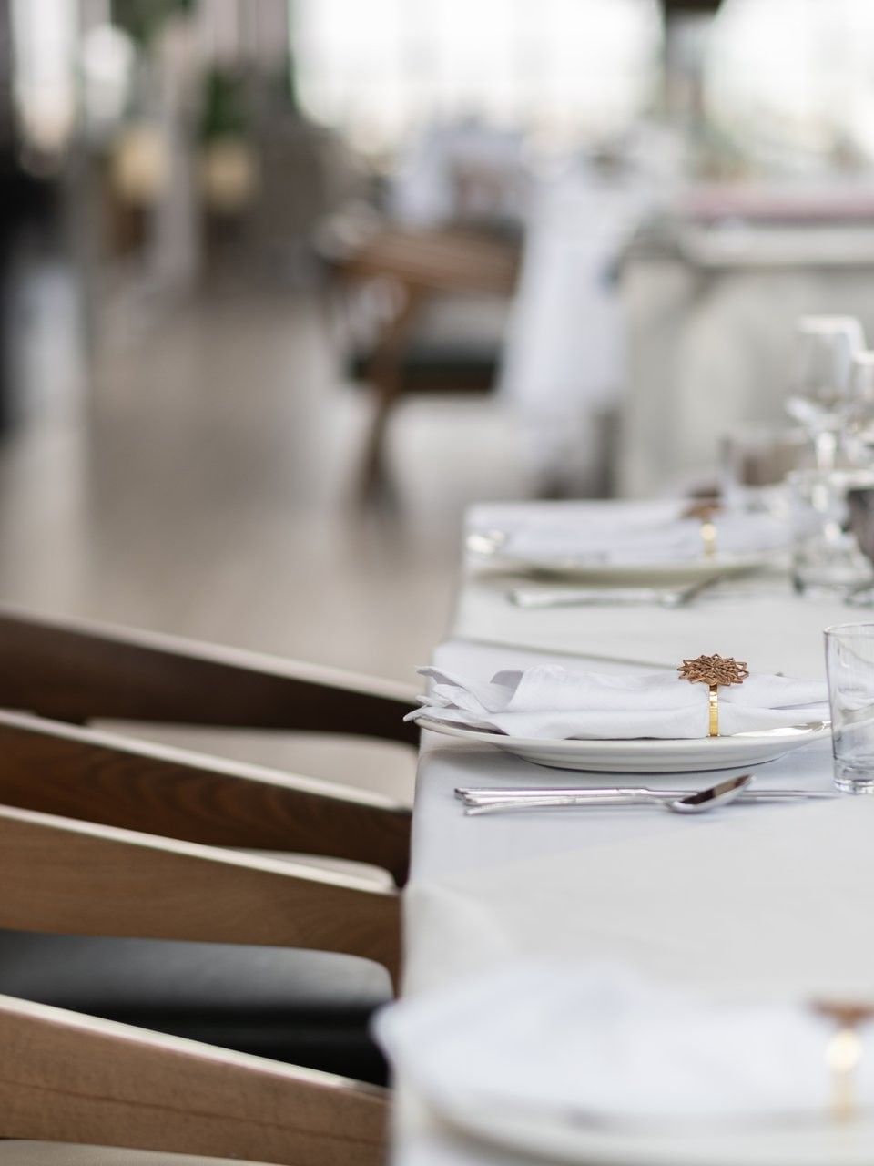 Elegant glassware by white linens under soft lighting at a dining table in Karkan Restaurant at Warwick Al Taif Hotel