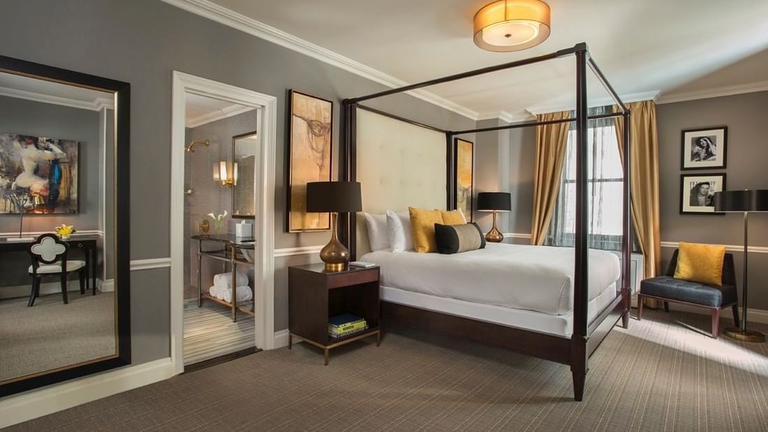 Elegant Jane Suite bedroom with a canopy bed and modern decor at Warwick New York