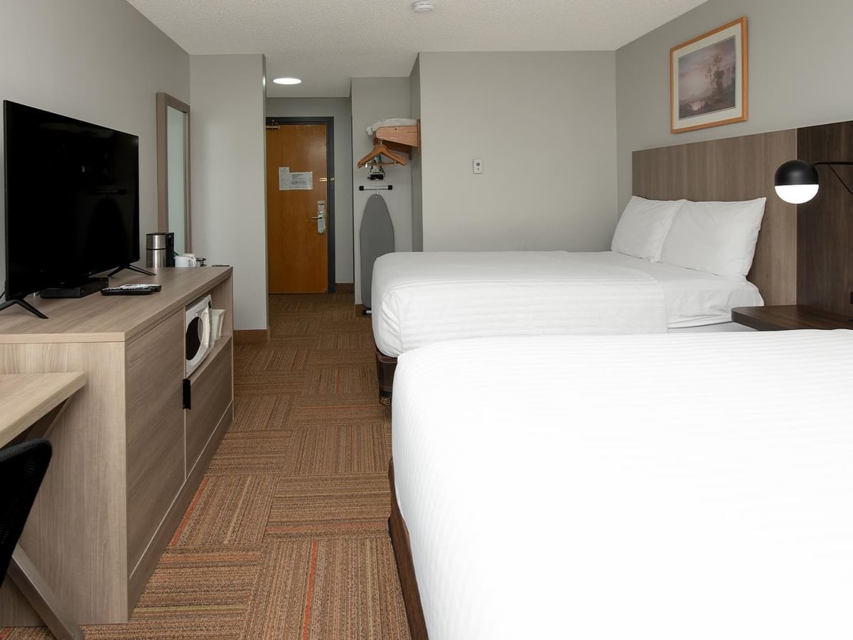 Coast Two Queens room with two queen beds, modern wood accents and flat-screen TV.