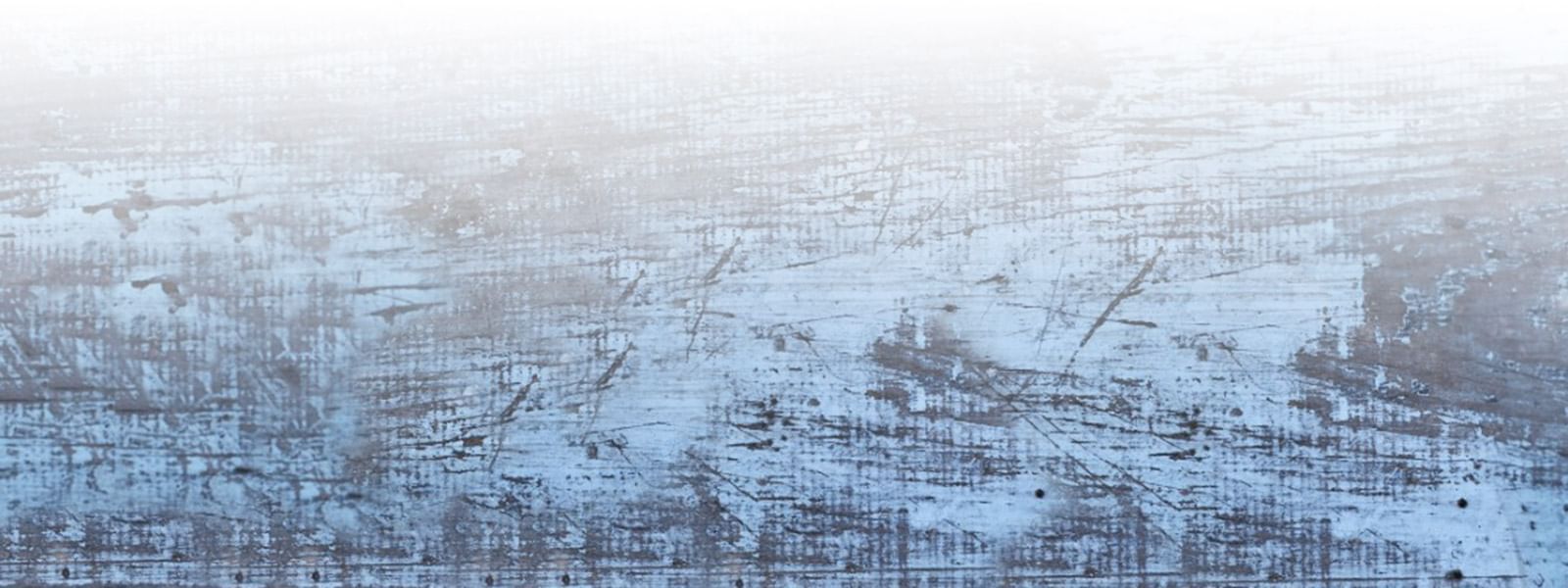 Light blue and white distressed wood texture with subtle scratches, used as a background at Marbella Club