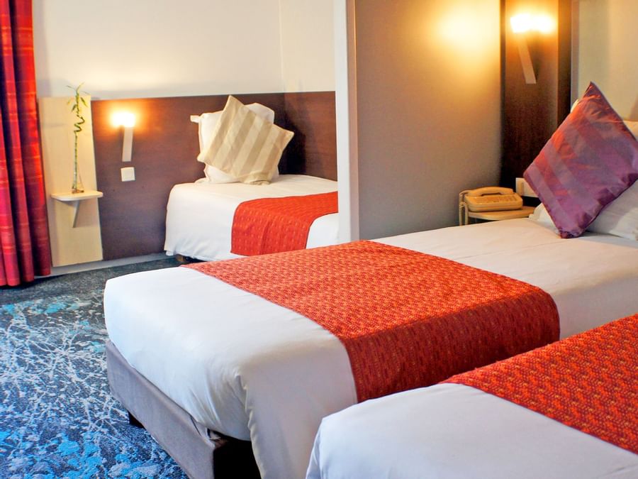 Beds in Triple comfort room at The Originals Hotels