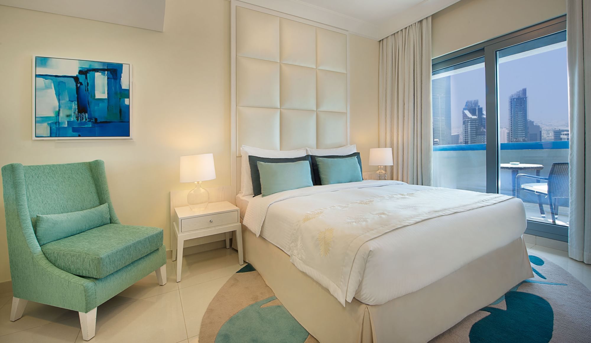Bed with nightstands and city view in Three Bedroom Suite, hotel room in Dubai at DAMAC Maison Mall Street
