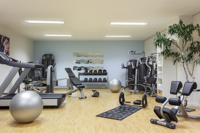 Exercise equipment in Fitness Room with wooden floors at Starling Hotels in Lausanne Switzerland